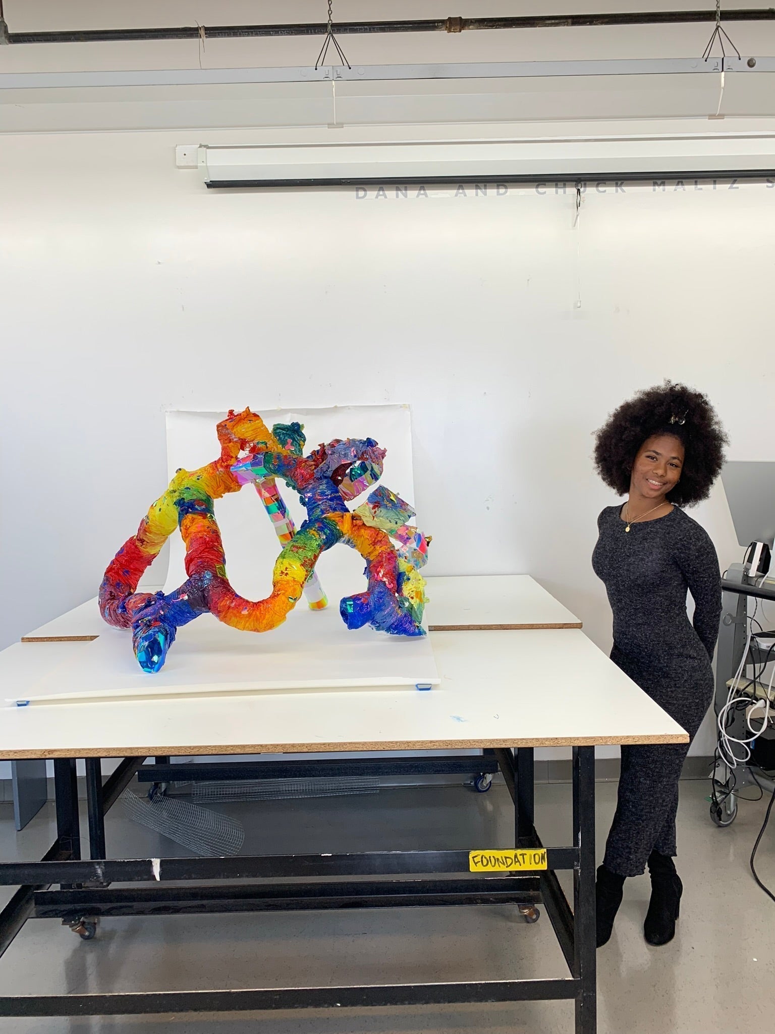 Nene is the second twin showcasing her wildly abundant colorful energetic sculpture that looks very swirly and dynamic with holographic chrome sheets and high saturated acrylic color paint in a rainbow order