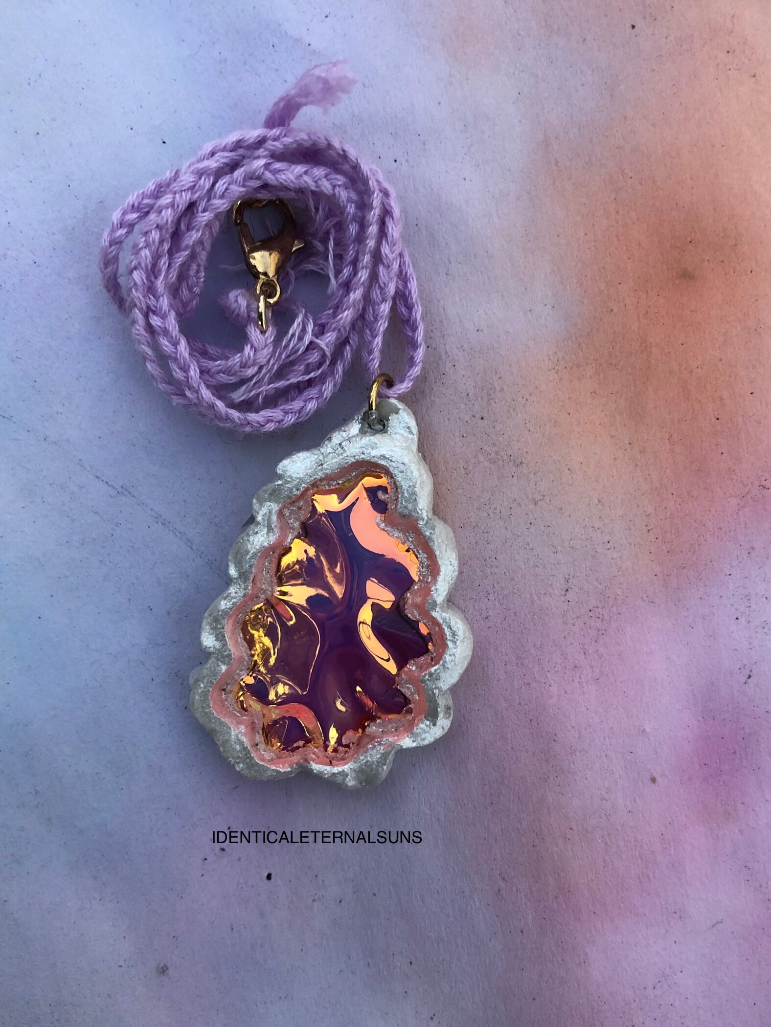 Necklace with a unique pendant on a textured surface