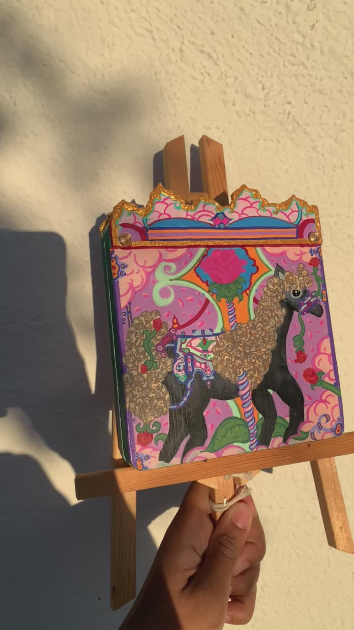 Colorful carousel-themed pony mini painting artwork. The Miraculous Carousel Girls wooden painting book, vibrantart, equineart, carouselride, merrygoroundmagic, immersiveart, nostalgickidcore, hopefulart, innocentjoy, nurserydecor, babygirlroom, childlikemagic, playfulimagination, joyfulplaytime, majesticlookbook, nurserybabyart, babygirldecor, cherishablekeepsakes, functionalsurrealism, surrealismsculpture